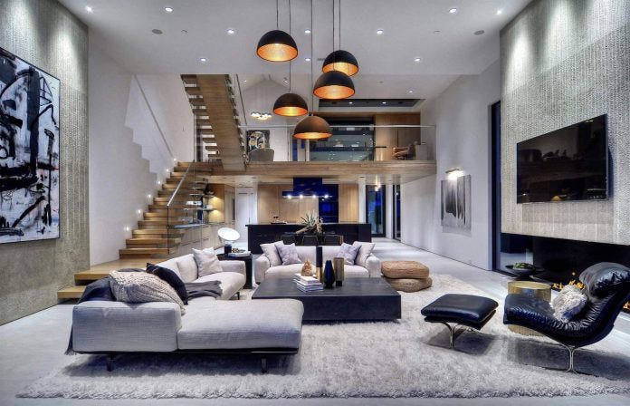 Modern living room with a cozy sectional sofa and pendant lighting.